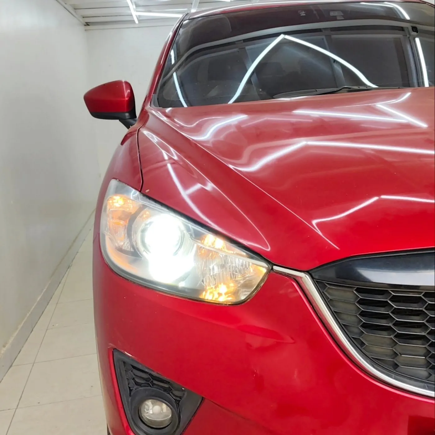 Clear headlight lens on a red Mazda CX-5