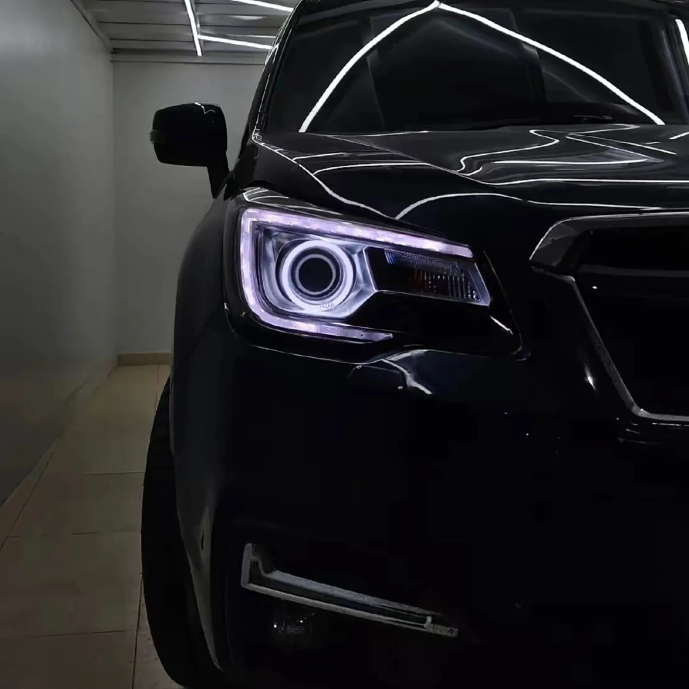 Subaru Forester ring lit in a dark bay