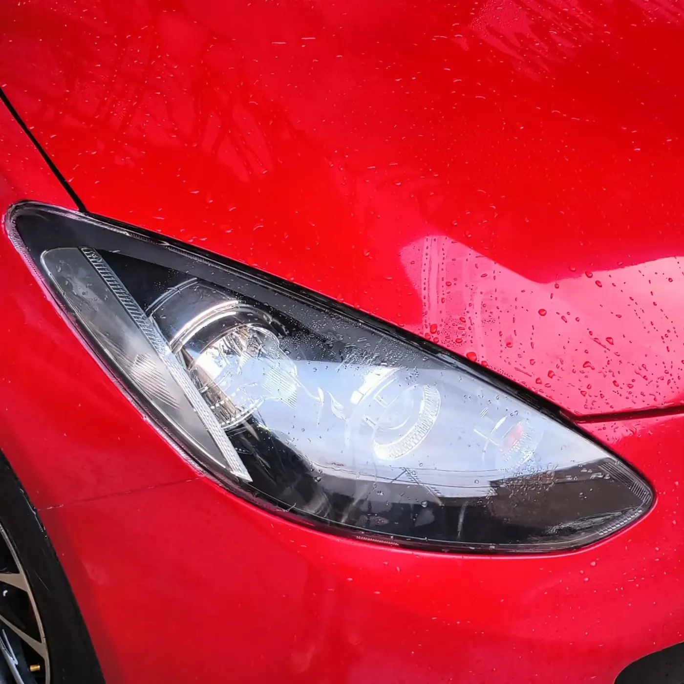 Clear headlight lens on a red car